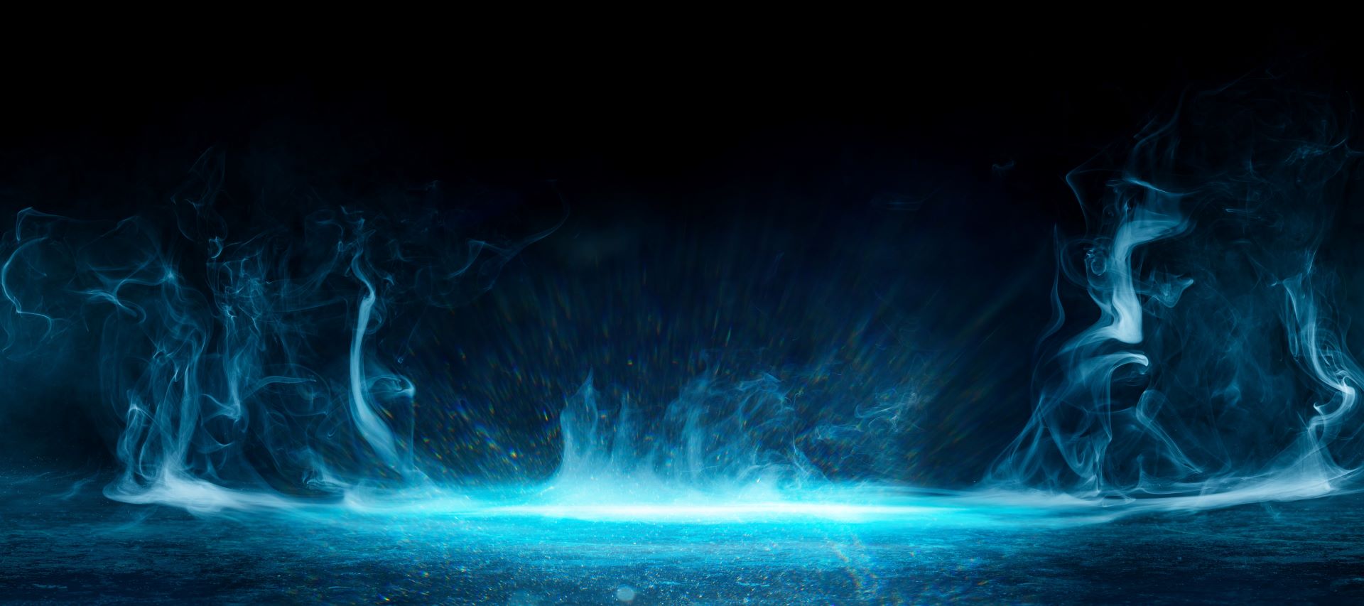 An abstract image of a deep blue background with light blue, smoky, water-like flames gently rising upwards, creating a fluid effect. 