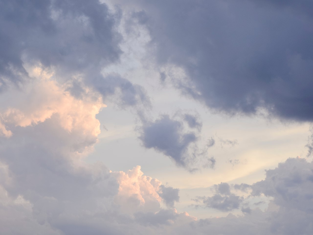 A sky with fluffy clouds tinged by the sun, creating a serene atmosphere with a sense of fresh air