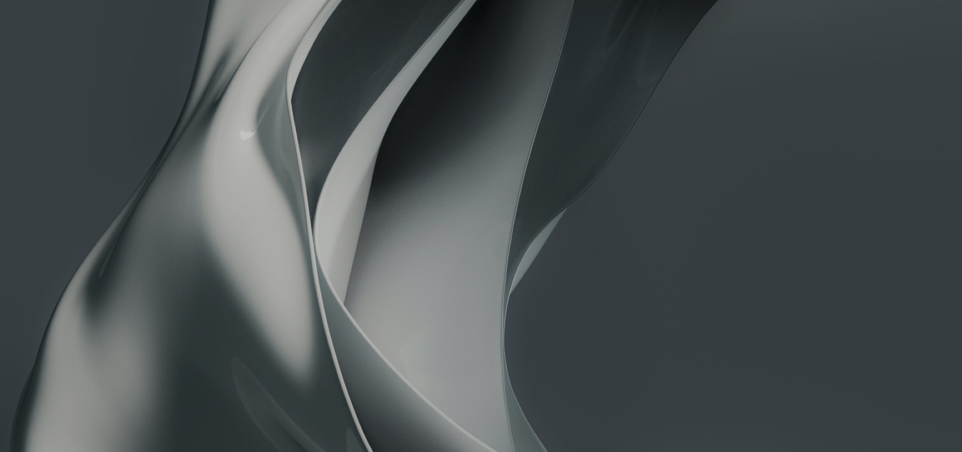 fluid, overlapping shapes in dark grey tones, creating a smooth, metallic texture with a sense of motion and depth