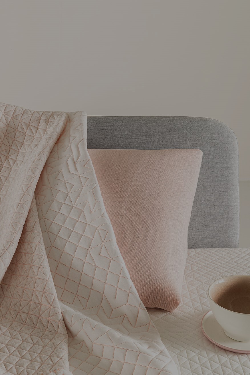Mattress and pillow fabrics in grey, pink and white colors.