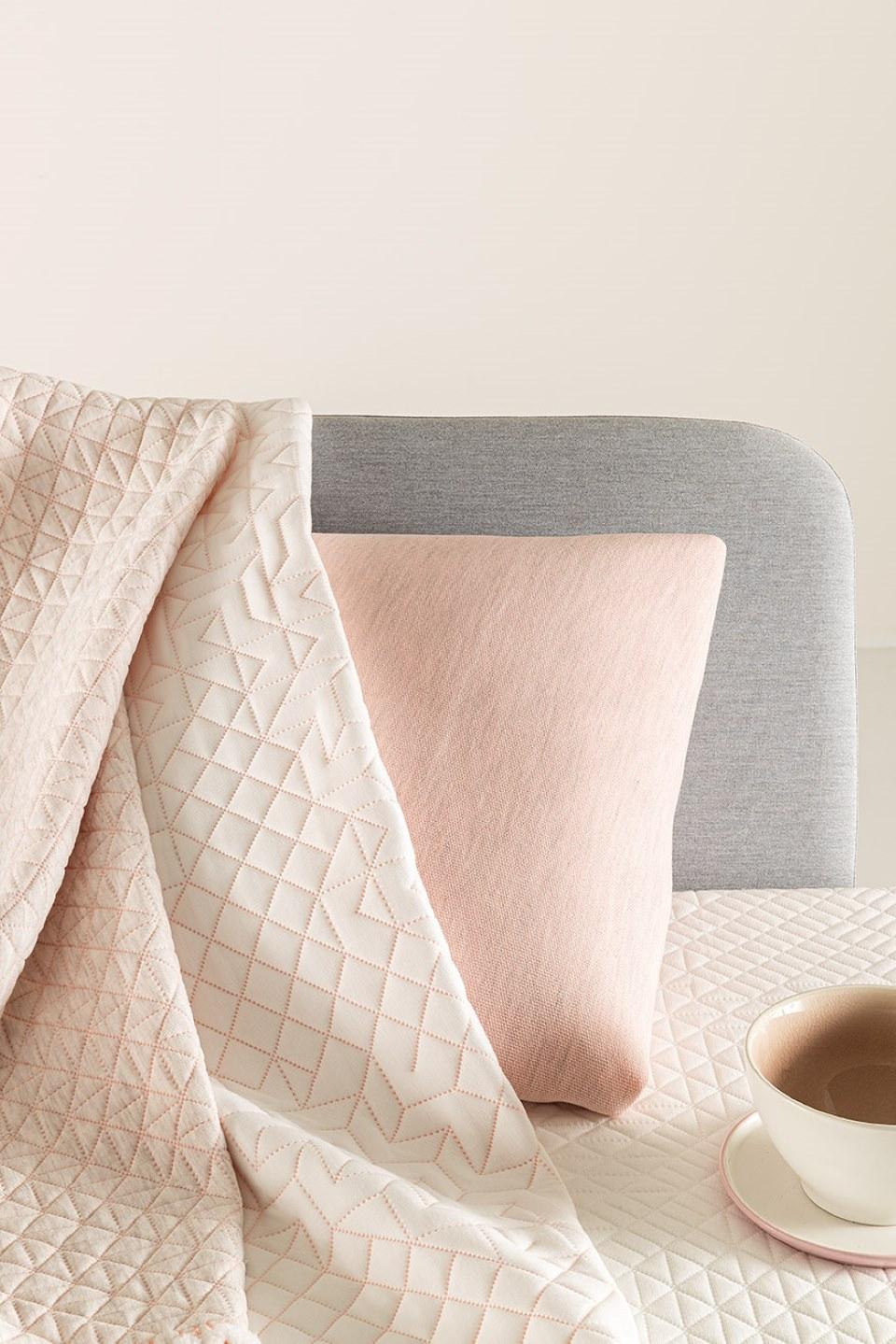 Mattress and pillow fabrics in grey, pink and white colors.