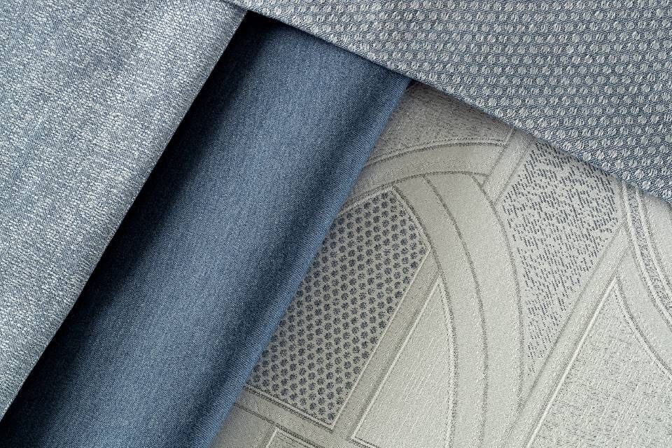 Elegant blue and gray layered textiles with intricate weaves and rich textures