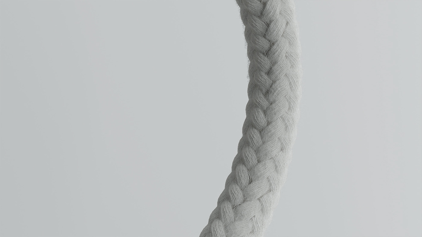 Close-up of a white braided yarn thread against a gray background, highlighting its intricate texture.